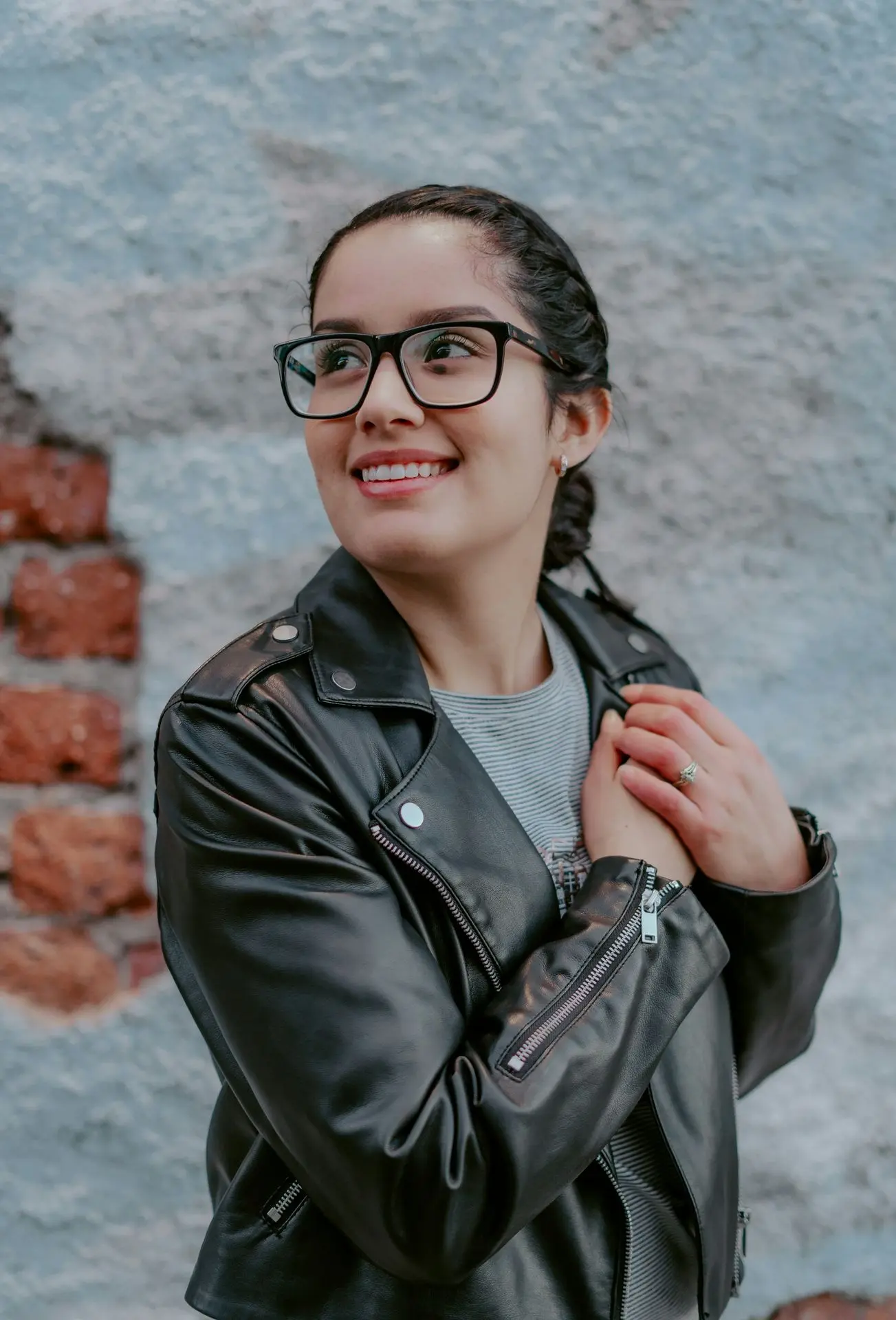 woman in black leather jacket wearing black framed eyeglasses